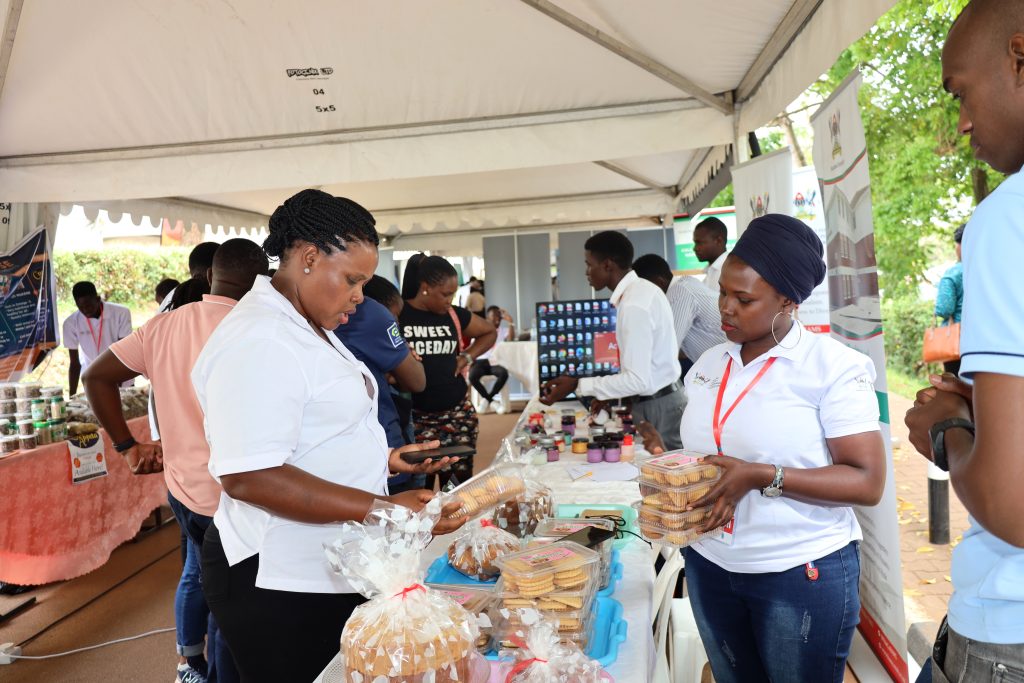 Dr. Sara Bimbona (Left) interacts with exhibitors from CoBAMS. Youth and Innovation Expo held 6th-7th October 2023. Yusuf Lule Central Teaching Facility, Makerere University, Kampala Uganda. East Africa.