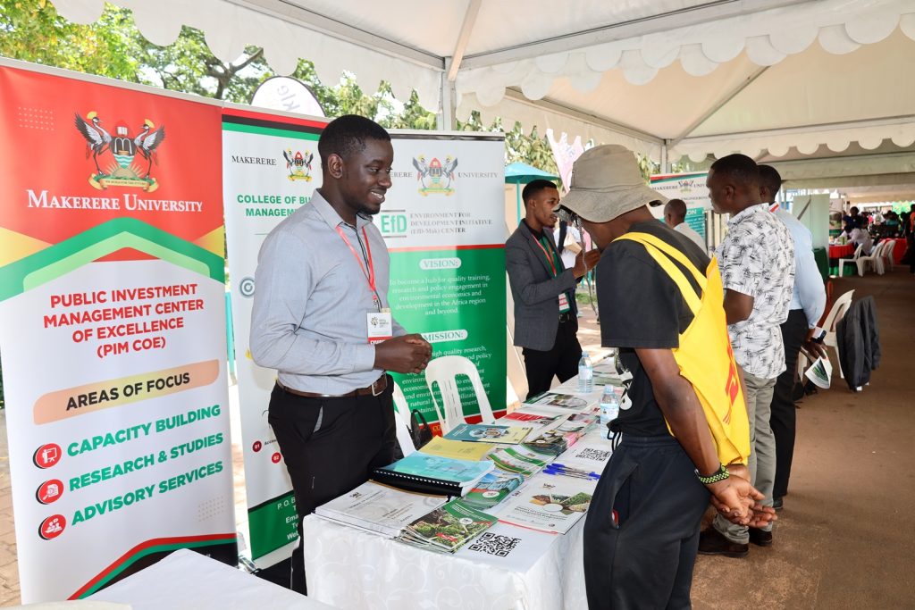 Exhibitors from the Public Investment Management (PIM) Centre of Excellence interact with visitors in the CoBAMS tent. Youth and Innovation Expo held 6th-7th October 2023. Yusuf Lule Central Teaching Facility, Makerere University, Kampala Uganda. East Africa.