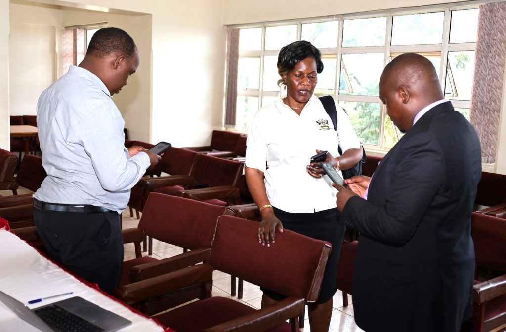 Left to Right: Dr. Peter Nabende, Dr. Joyce Bukirwa Muwanguzi and Peter Eneru exchanging contacts after the meeting. Conference Hall, Level 4, Block A, College of Computing and Information Sciences (CoCIS), Makerere University, Kampala Uganda, East Africa.