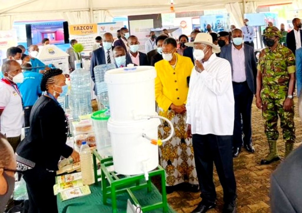 President Yoweri Museveni and First Lady Hon. Janet Museveni listen to Dr. Alice Nabatanzi (Left) explain how the three of the innovations she showcased work. Photo: Courtesy/NCHE@20, Kololo Ceremonial Grounds. Kampala, Uganda, East Africa.