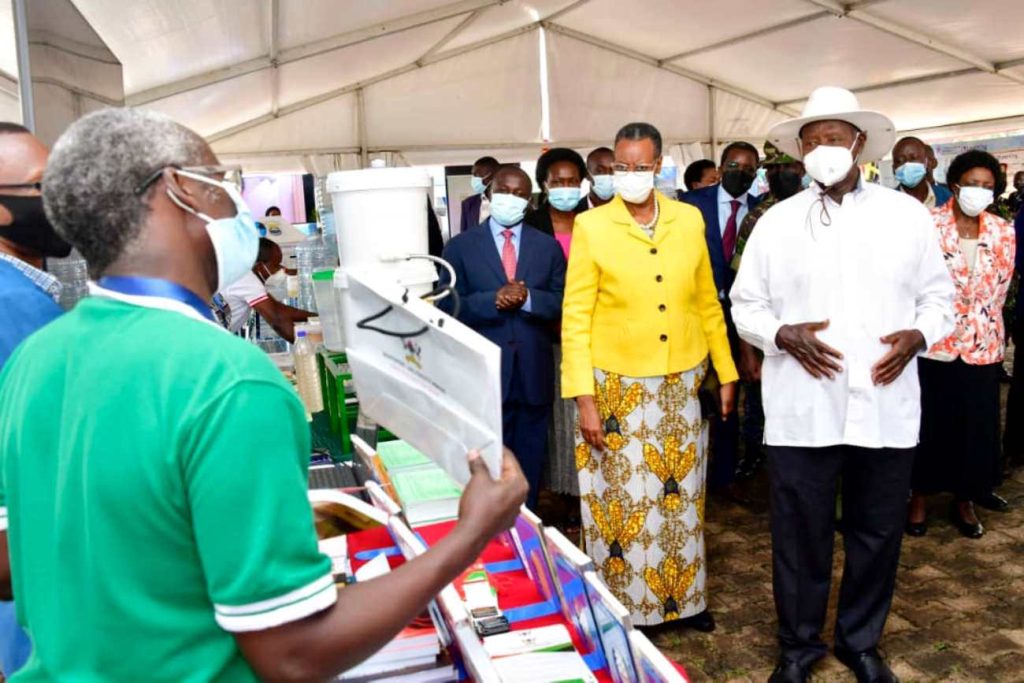 President Yoweri Museveni and First Lady Hon. Janet Museveni listen to Dr. William Tayeebwa (Back to camera) talk about the Makerere University Press. Photo: PPU. NCHE@20, Kololo Ceremonial Grounds. Kampala, Uganda, East Africa.