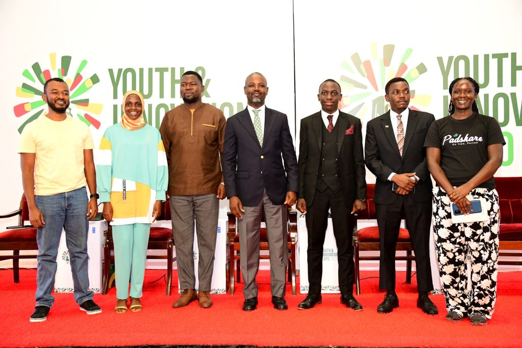 Rt. Hon. Thomas Tayebwa (4th L) with the Guild President-H.E. Robert Maseruka (3rd R), Vice Guild President-H.E. Mariat Namiiro (2nd L) and Panelists: Chairperson of the National Youth Council-Mr. Jacob Eyeru (3rd L), Founder PADShare-Sandra Awili (R) and CEO Chap Chap Africa-Emmanuel Emodek. Youth and Innovation Expo 2023, Yusuf Lule Central Teaching Facility, Makerere University, Kampala Uganda, East Africa.