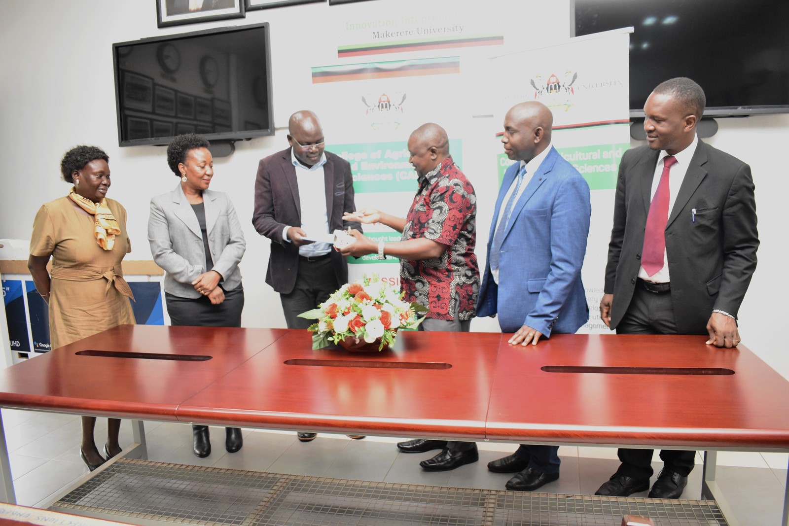 Prof. Nelson Turyahabwe (3rd R) hands over some of the office property to Dr Bernard Obaa (3rd L). Conference Room, 13th November 2023, CAES, Makerere University, Kampala Uganda, East Africa.