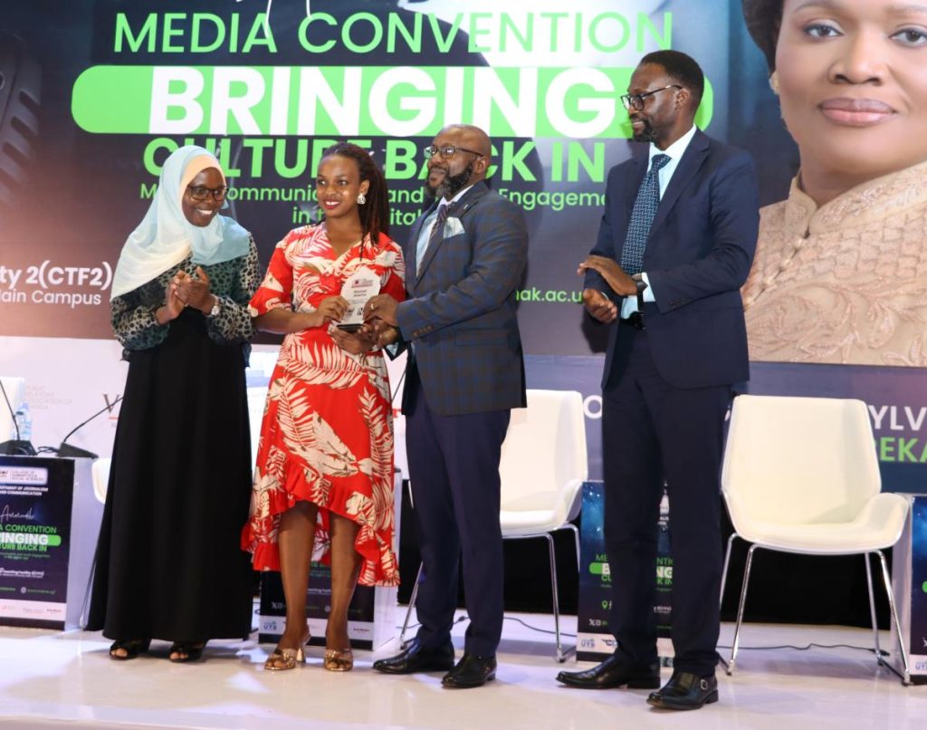 Atwine Rhonet receives the Cranimer Mugerwa Award from the New Vision CEO Don Wanyama (2nd Right). Annual Media Convention, 12th October 2023, Yusuf Lule Central Teaching Facility Auditorium, Makerere University, Kampala Uganda, East Africa.