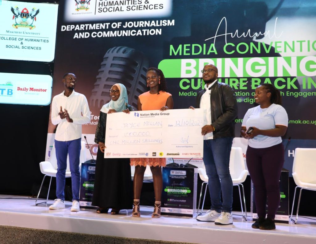 Joyce Mollan receives the Tebere Maudin award from the Daily Monitor's Daniel Kalinaki (2nd Right). Annual Media Convention, 12th October 2023, Yusuf Lule Central Teaching Facility Auditorium, Makerere University, Kampala Uganda, East Africa.