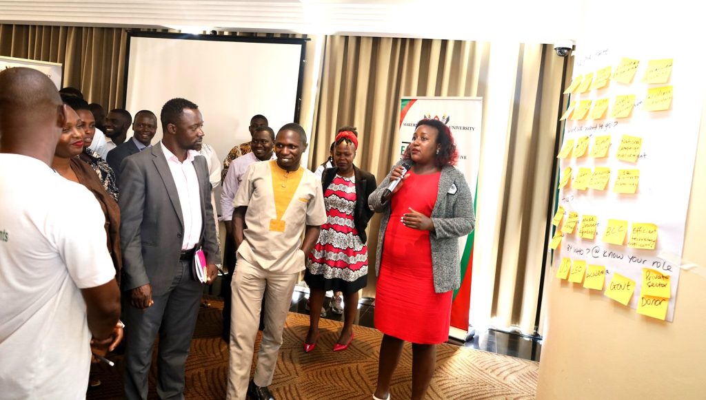 One of the female participants (Right) presenting on behalf of Group One. Makerere EfD Stakeholders Meeting, Transitioning from Biomass to Clean Energy Sources, 17th November 2023, Kampala Sheraton Hotel, Uganda, East Africa.