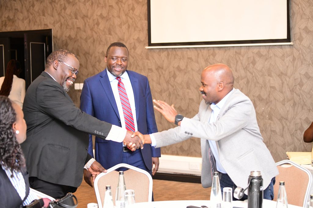 Dr. Henry Onoria (Left) shakes hands with Dr. Robert Kakuru (Right) as the University Secretary, Mr. Yusuf Kiranda (Centre) introduces him to leaders in attendance. Makerere University Staff Appeals Tribunal Swearing-In Ceremony, 16th November 2023, Mestil Hotel, Kampala Uganda.