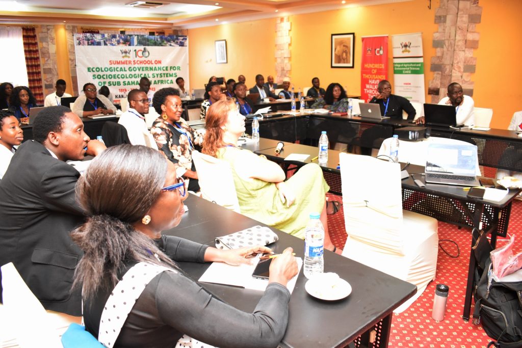 Participants follow the proceedings of the 2023 Summer School. Makerere University Summer School on Ecological Governance for Socioecological Systems for Sub-Saharan Africa, 18th-27th July 2023, Royal Suites Hotel, Bugolobi, Kampala, Uganda, East Africa.