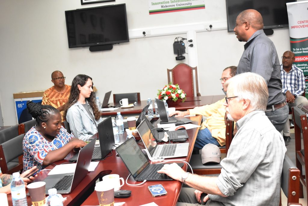 Dr. Godfrey Chigeza from IITA, Zambia (Standing) responds to queries from Prof. Tukamuhabwa about his presentation. Africa Soybean Breeders Meeting, 28th November to 1st December 2023, Makerere University, MUARIK, Kampala Uganda, East Africa.