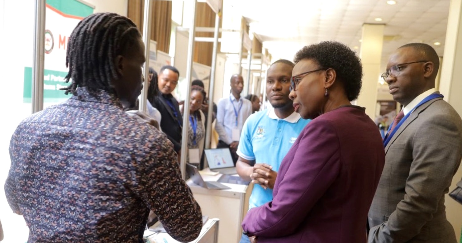 The Minister of Health, Hon. Dr. Jane Ruth Aceng (2nd R) visiting the METS stall manned by Jaba Jeremiah (L) and Musa Mwanje (blue polo shirt) at the First National Digital Health Conference held 13th - 14th November 2023. Photo: METS. Kampala Serena Hotel, Kampala Uganda, East Africa.