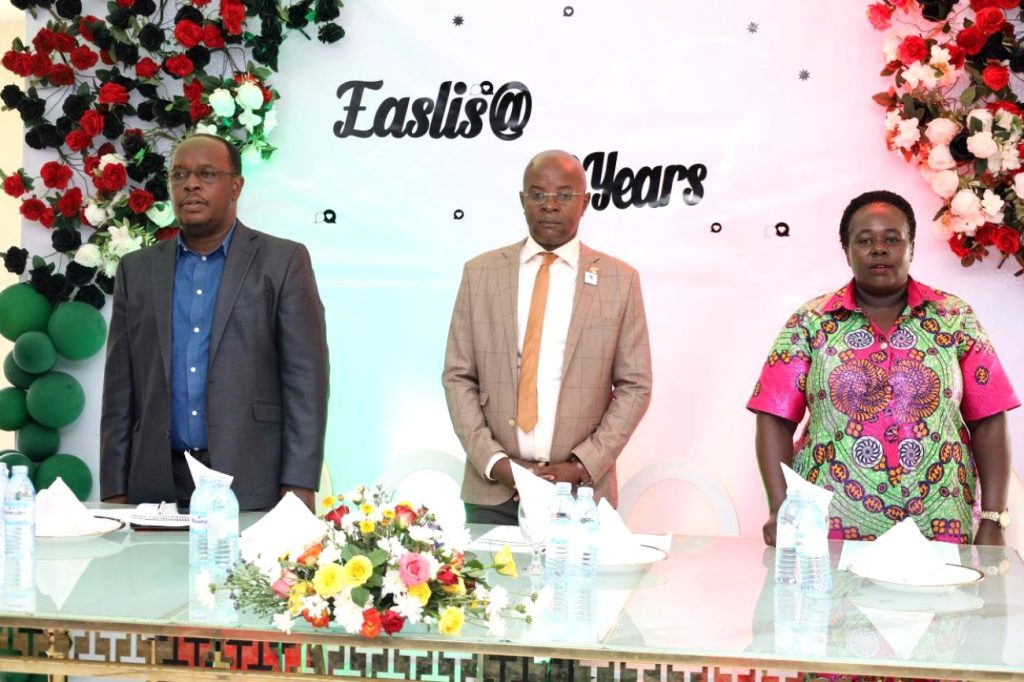 Left to Right: Dr. Peter Nabende, Prof. Edward Bbaale and Dr. Sarah Kaddu standing for the national anthems during the closing ceremony. EASLIS@60 Luncheon, 10th November 2023, Big Lab 2, Block B, College of Computing and Information Sciences (CoCIS), Makerere University, Kampala Uganda, East Africa.
