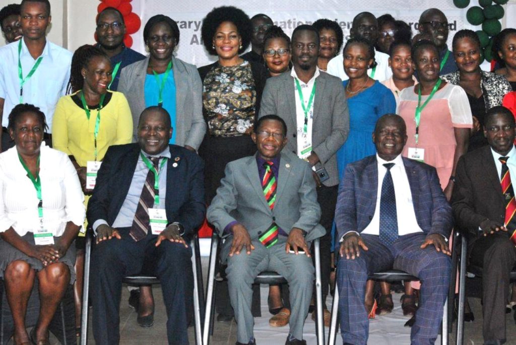 Prof. Tonny Oyana (2nd L), Prof. Buyinza Mukasi (C), Hon. Muruli Mukasa (2nd R) and Dr. Cyprian Misinde (R) in group photo with a section of participants after the opening ceremony. EASLIS@60 Conference, 8th-10th November 2023, Big Lab 2, Block B, College of Computing and Information Sciences (CoCIS), Makerere University, Kampala Uganda, East Africa.