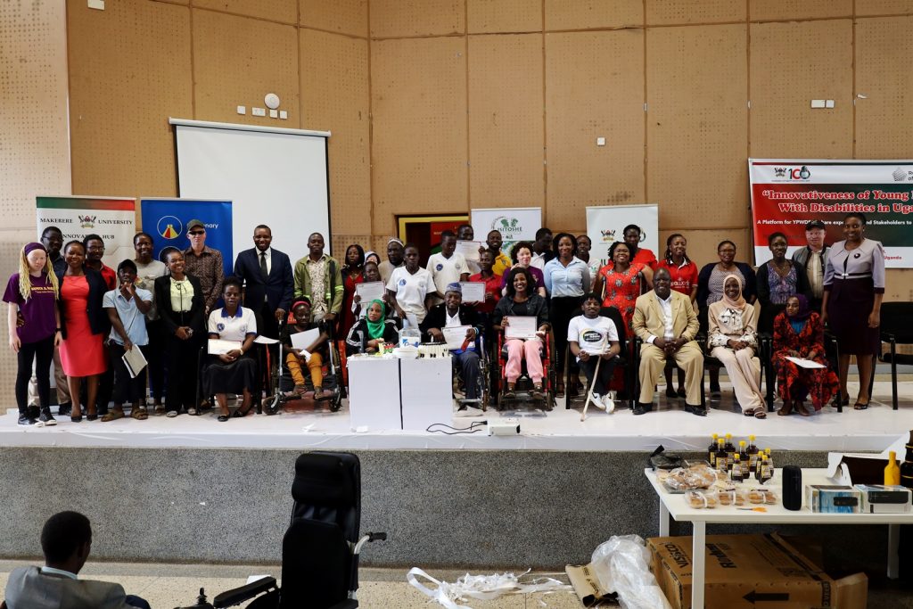 Dr. Cathy Mbidde (Right) with officials and some of the persons living with disabilities pose for a group photo. Yusuf Lule Central Teaching Facility Auditorium, Makerere University, Kampala Uganda, East Africa.