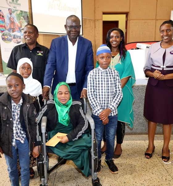 Standing: Dean School of Business-Prof. Godfrey Akileng (2nd Left), Head Department of Marketing and Management-Prof. Peter Turyakira (Left), Director, Makerere University Innovations Hub and Project PI-Dr. Cathy Mbidde (Right) with officials and some of the persons living with disabilities during the celebrations on 1st December 2023. Yusuf Lule Central Teaching Facility Auditorium, Makerere University, Kampala Uganda, East Africa.
