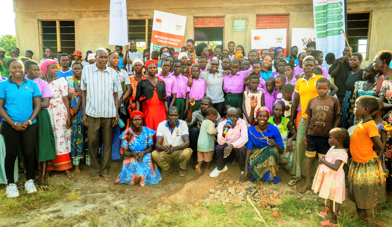 Scholars, Alumni and the community of Achukudu Primary School during the commissioning of the classroom block on 2nd December 2023. Makerere University Mastercard Foundation Scholars and Alumni Annual Day of Community Service (Giveback), 2nd December 2023, Achukudu Community Primary School, Napak District, Karamoja, Uganda, East Africa.