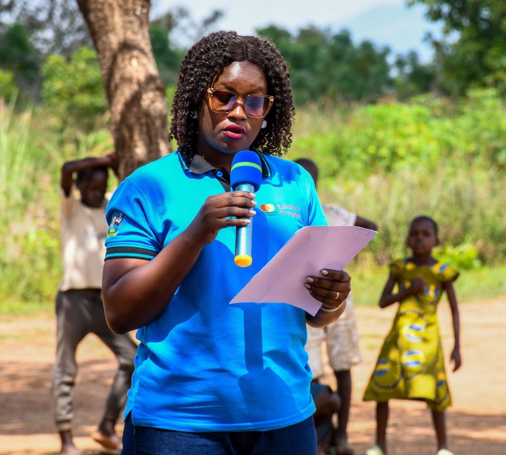 Ms. Jolly Okumu, the Program Manager of Mastercard Foundation Scholars Program at Makerere University. Makerere University Mastercard Foundation Scholars and Alumni Annual Day of Community Service (Giveback), 2nd December 2023, Achukudu Community Primary School, Napak District, Karamoja, Uganda, East Africa.