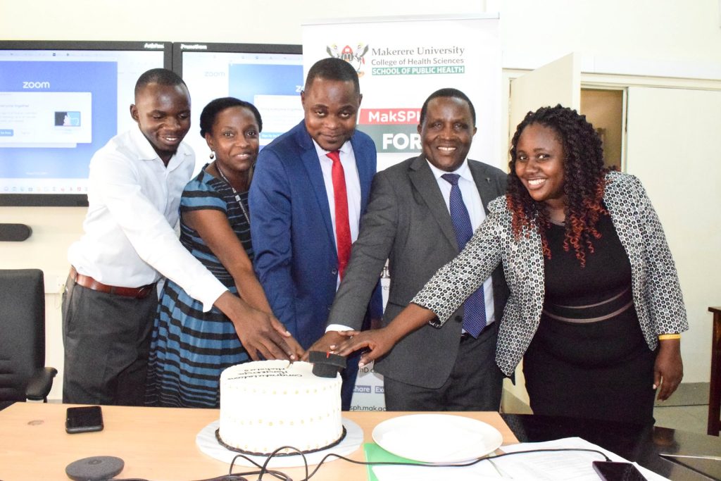 Dr. Nicholus Nanyeenya cuts cake shortly after his PhD Defense on Thursday, December 7, 2023. College of Health Sciences, Makerere University, Kampala Uganda, East Africa.