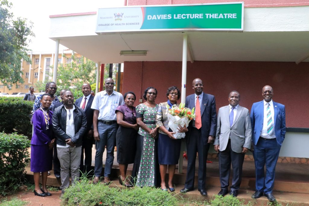 Dr. Sarah Bunoti (holding flowers) in a group photo with her PhD supervisors, examiners and family after her PhD defense. Davies Lecture Theatre, College of Health Sciences, Makerere University, Kampala Uganda, East Africa.