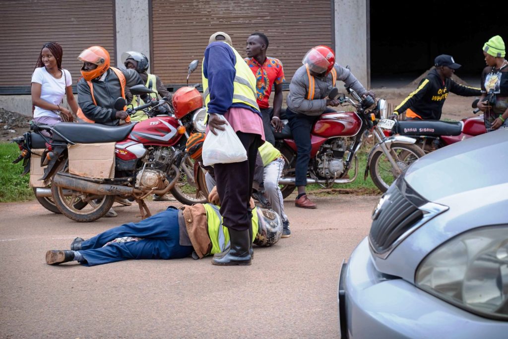 A cyclist lying on the ground following an accident in Kampala. Photo by Katumba Badru Sultan