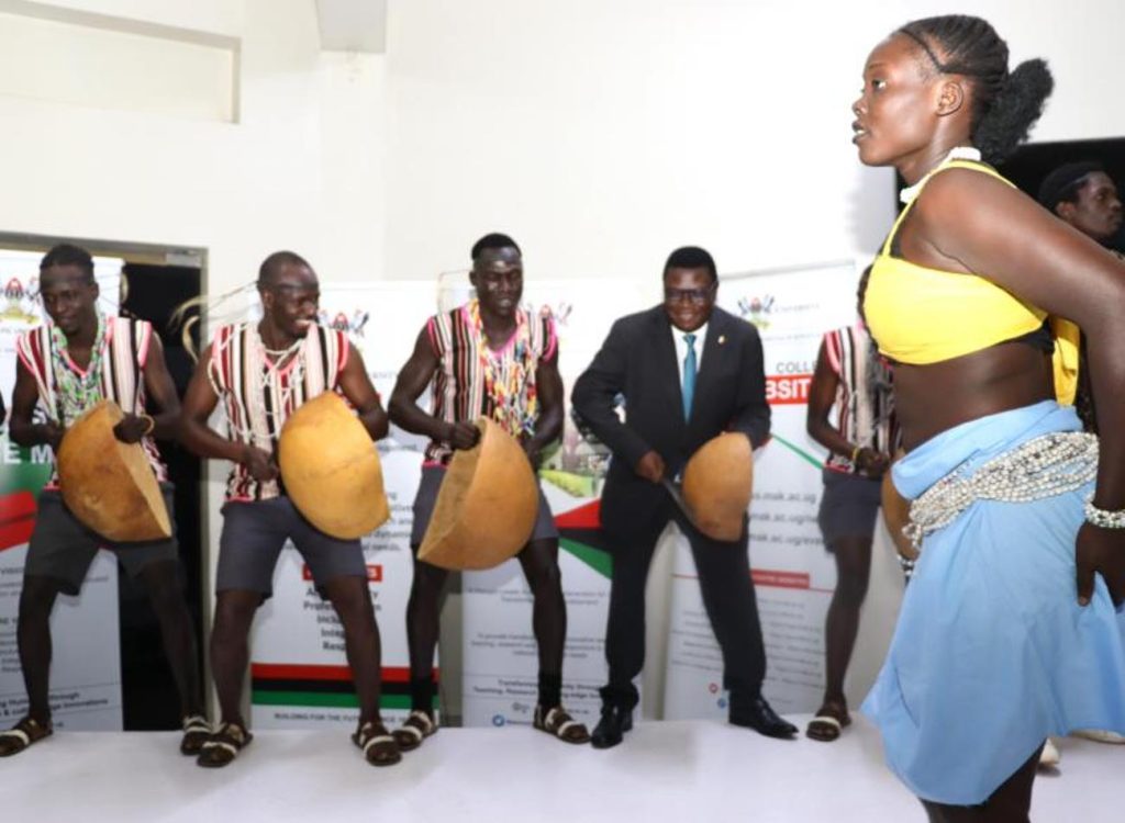 Hon. Norbert Mao (4th Left) joins students of Performing Arts and Film to entertain guests. National convention to foster national conversation on floating populations, specifically the Aguu phenomenon, 14th December 2023, Fairway Hotel, Kampala Uganda, organised by CHUSS and Amani Institute.