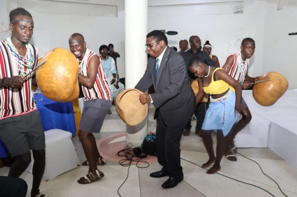 Hon. Norbert Mao (in black suit) joins Mak PAF students in Acholi dance. National convention to foster national conversation on floating populations, specifically the Aguu phenomenon, 14th December 2023, Fairway Hotel, Kampala Uganda, organised by CHUSS and Amani Institute.