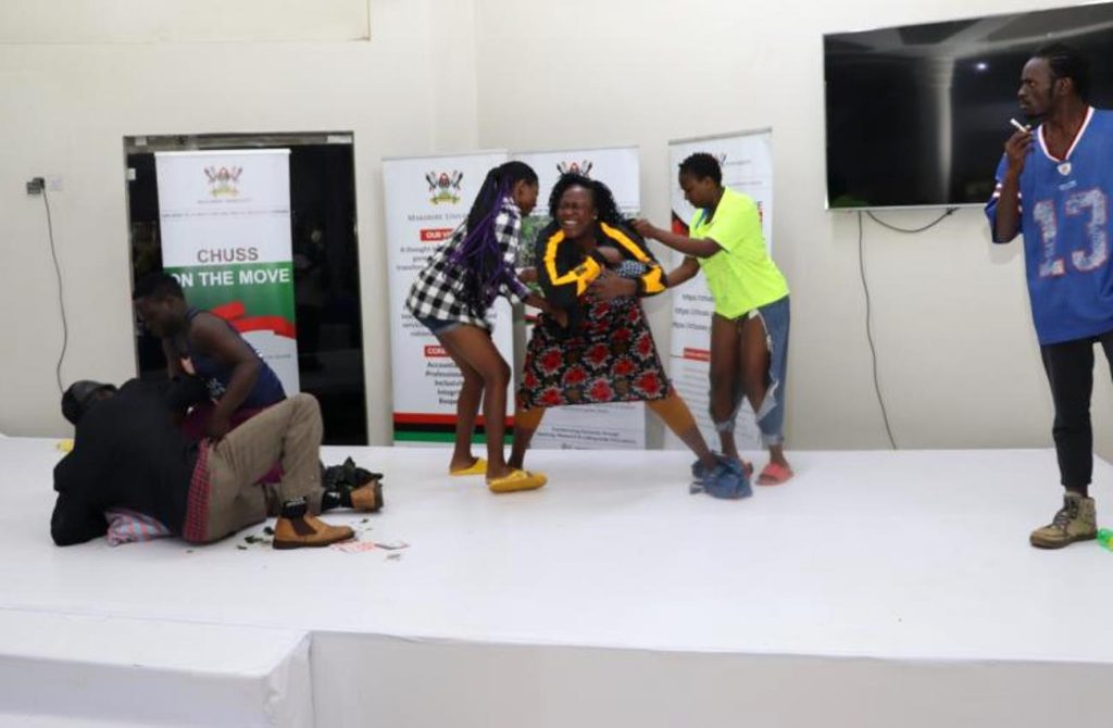 Mak PAF students perform on stage how the Aguus terrorise and waylay people and rob them. National convention to foster national conversation on floating populations, specifically the Aguu phenomenon, 14th December 2023, Fairway Hotel, Kampala Uganda, organised by CHUSS and Amani Institute.