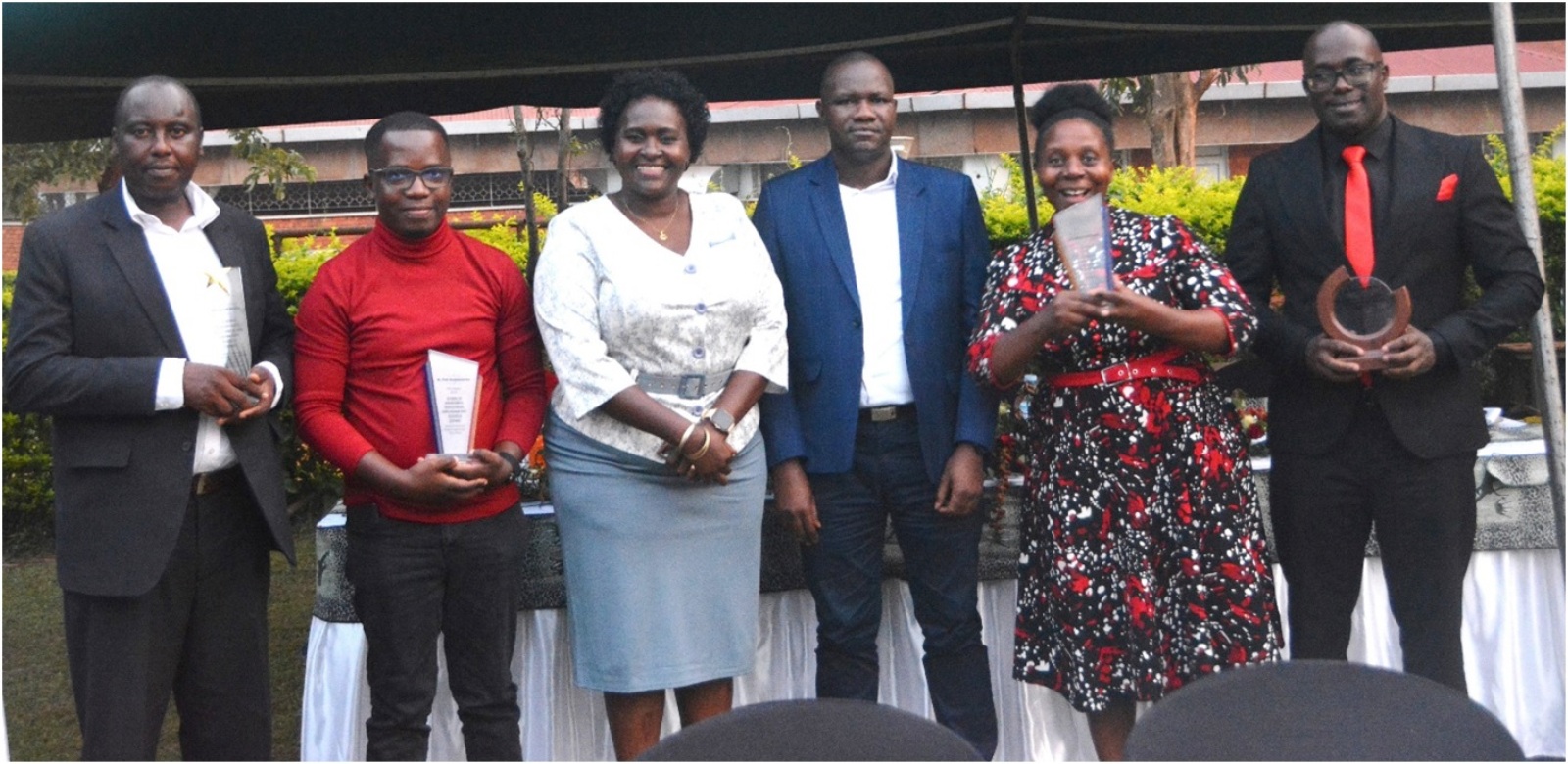 Some of the staff that were sent off pose for a picture after receiving their plaques. CoVAB farewell for outgoing staff, 19th January 2024, Ruth Keesling Gardens, College of Veterinary Medicine, Animal Resources and Biosecurity (COVAB), Makerere University, Kampala Uganda, East Africa.