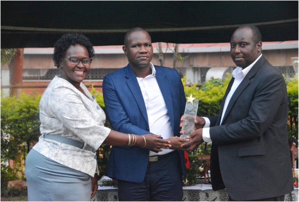 Prof. Samuel Majalija (R) receives his plaque. CoVAB farewell for outgoing staff, 19th January 2024, Ruth Keesling Gardens, College of Veterinary Medicine, Animal Resources and Biosecurity (COVAB), Makerere University, Kampala Uganda, East Africa.