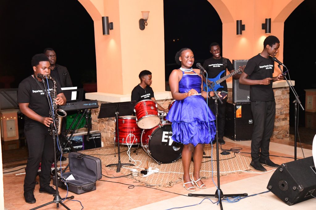 The Department of Performing Arts and Film led by the Chair, Dr. Benon Kigozi (Rear Left) perform during the dinner. University Council Dinner in honour of Prof. Ezra Suruma's two terms as Chancellor, 20th December 2023, Lake Victoria Serena, Kigo, Kampala Uganda, East Africa.