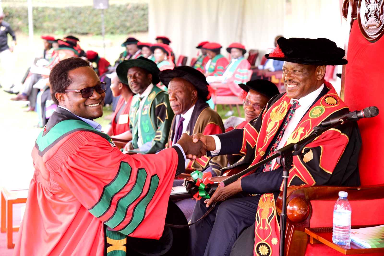 Professor Barnabas Nawangwe (Right) presents Dr. James Muleme with his award upon conferment on 29th January 2024. 74th Graduation Ceremony, Day 1, School of Public Health, College of Health Sciences (CHS), 29th January 2024, Freedom Square, Makerere University, Kampala Uganda, East Africa.