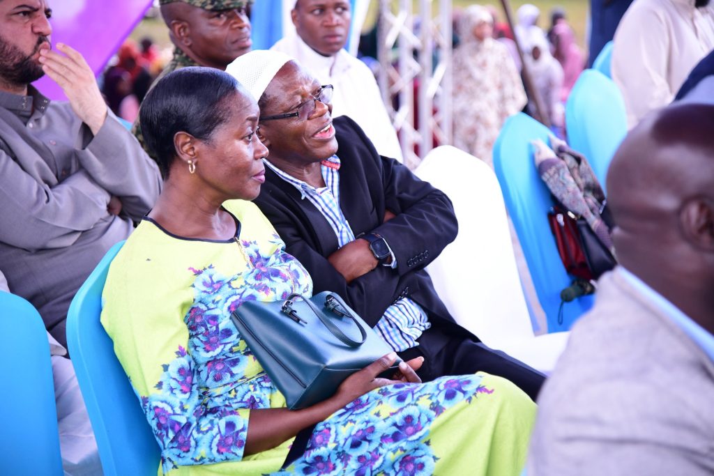 Mrs. Winifred Kabumbuli (Left) and Prof. Buyinza Mukadasi (Right) follow proceedings. Mufti Menk Visit and Public Lecture, 8th March 2024, Rugby Grounds, Makerere University, Kampala Uganda, East Africa.