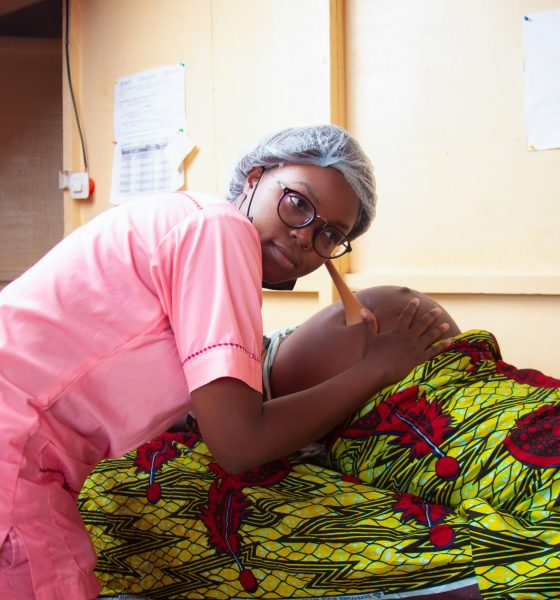 Pregnant woman with midwife. Photo by Iwaria Inc. on Unsplash
