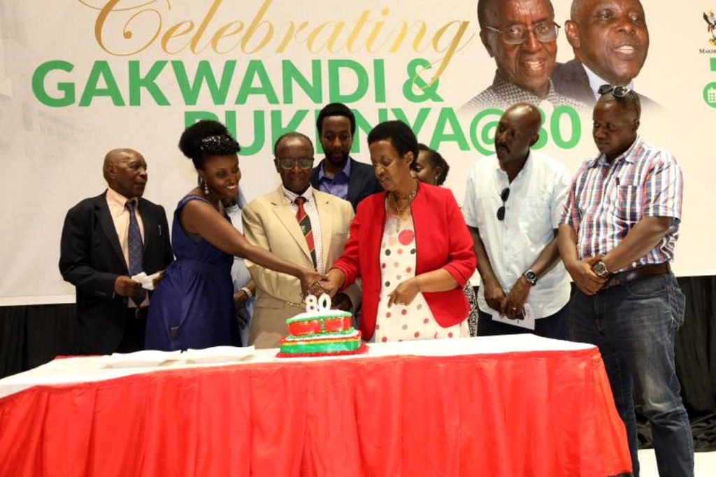 Prof. Arthur Gakwandi and family cutting the cake. The Department of Literature, School of Languages, Literature and Communication, College of Humanities and Social Sciences (CHUSS) Celebrates Prof. Arthur Gakwandi and Prof. Austin Bukenya at 80, 5th April 2024, The Auditorium, Yusuf Lule Central Teaching Facility, Makerere University, Kampala Uganda, East Africa.
