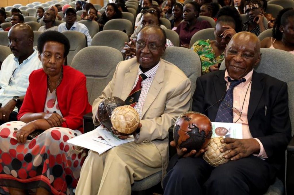 Prof. Austin Bukenya (Right) and Prof. Arthur Gakwandi (2nd Right) pose with some of the gifts they received at the event. The Department of Literature, School of Languages, Literature and Communication, College of Humanities and Social Sciences (CHUSS) Celebrates Prof. Arthur Gakwandi and Prof. Austin Bukenya at 80, 5th April 2024, The Auditorium, Yusuf Lule Central Teaching Facility, Makerere University, Kampala Uganda, East Africa.