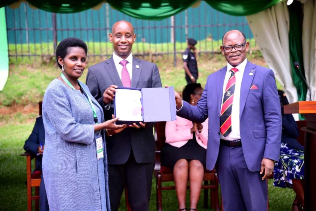 Prof. Barnabas Nawangwe (Right) presents a plaque to Mrs. Patience Mushengyezi (Left) as her husband and Vice Chanellor, Uganda Christian University, Prof. Aaron Mushengyezi (Centre) witnesses. Launch of the Digitalization of Academic Records and Processes (DARP) project by the Minister of Education and Sports, Hon. Janet Kataaha Museveni represented by the State Minister for Higher Education, Hon. John C. Muyingo, 19th April 2024, Freedom Square, Makerere University, Kampala Uganda.