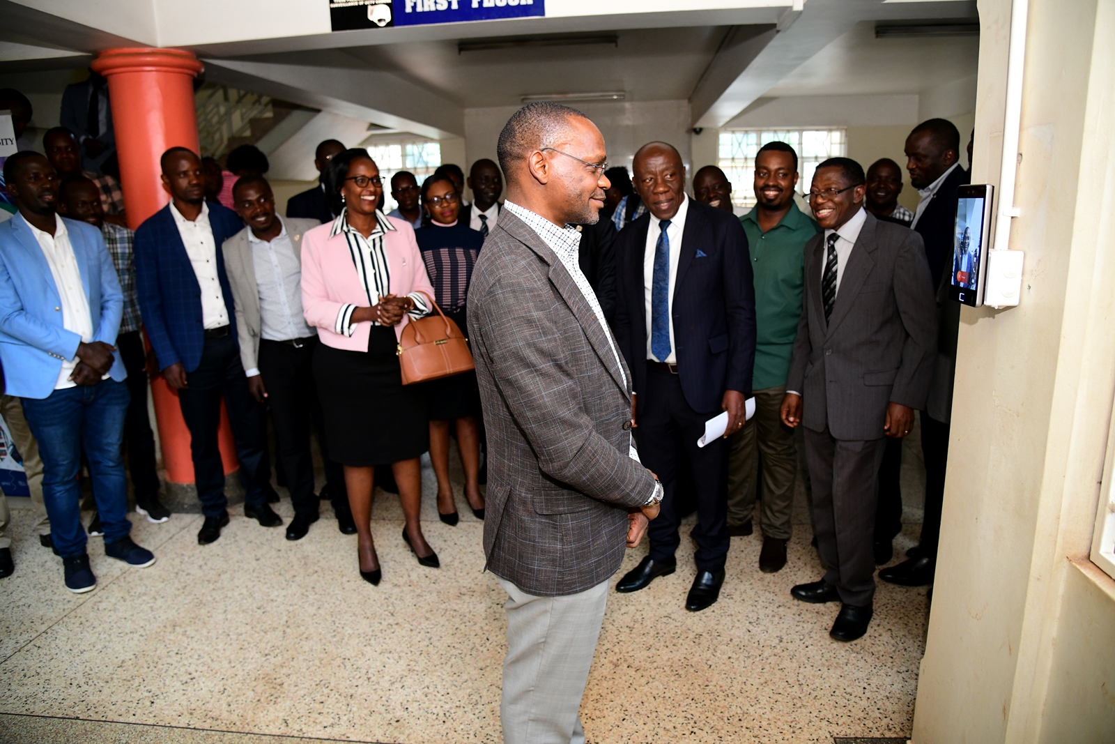 The DVCAA, Prof. Umar Kakumba uses the facial recognition feature of the biometric device at CoCIS. Launch of the staff and students attendance management system by Chairperson of Council, Mrs. Lorna Magara, 3rd May 2024, Conference Room, Level 4, College of Computing and Information Sciences (CoCIS), Makerere University, Kampala Uganda, East Africa.