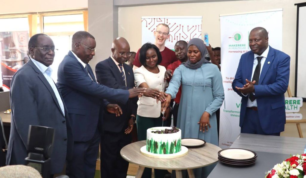 The Guest of Honor, University Management team and Panelists Cutting cake. Launch of AI Health Lab, Block B, College of Computing and Information Sciences (CoCIS), Makerere University, Kampala Uganda, East Africa.
