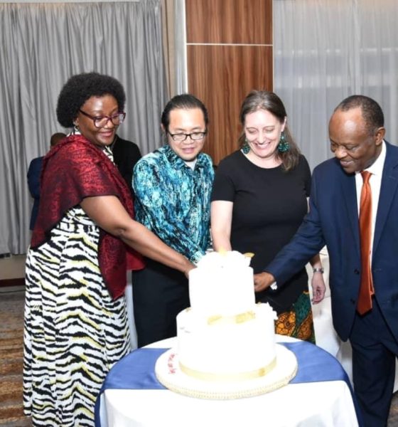 Makerere University School of Public Health (MakSPH) Dean, Prof Rhoda Wanyenze (Left), MoH Director General, Dr. Henry Mwebesa (Right) and other stakeholders join Dr. Amy Boore (2nd Right) to cut cake at her farewell event. Golden Tulip Hotel, Kampala Uganda, East Africa.