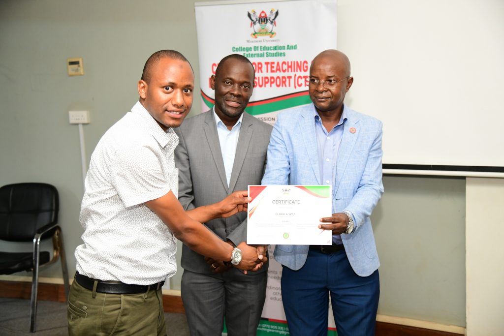 Prof. Bbaale (Right) and Prof. Mulumba (Centre) present a certificate to a male participant. Centre for Teaching and Learning Support (CTLS), College of Education and External Studies (CEES), Public Speaking Short Course for Twenty-five officials from the office of the parliamentary budget at the Parliament of Uganda, Certificate Award Ceremony, 17th May 2024, Senate Conference Hall, Makerere University, Kampala Uganda, East Africa.