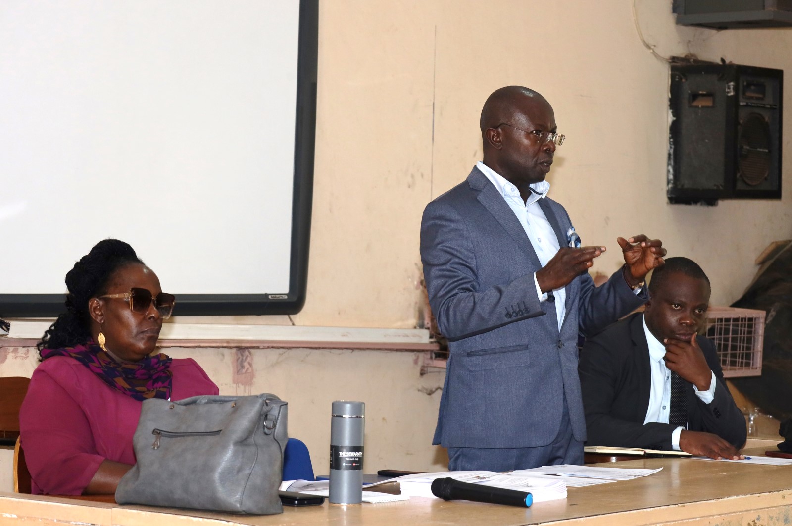 Dr. Muhammad Kiggundu Musoke (Centre) flanked by Ms. Joanna Kayaga (Left) and Mr. Kansiime Edward (Right) addresses students. College of Education and External Studies (CEES), Senior 6 students from Mbogo High School Career Guidance Session, August 2024, School of Education, Makerere University, Kampala Uganda, East Africa.