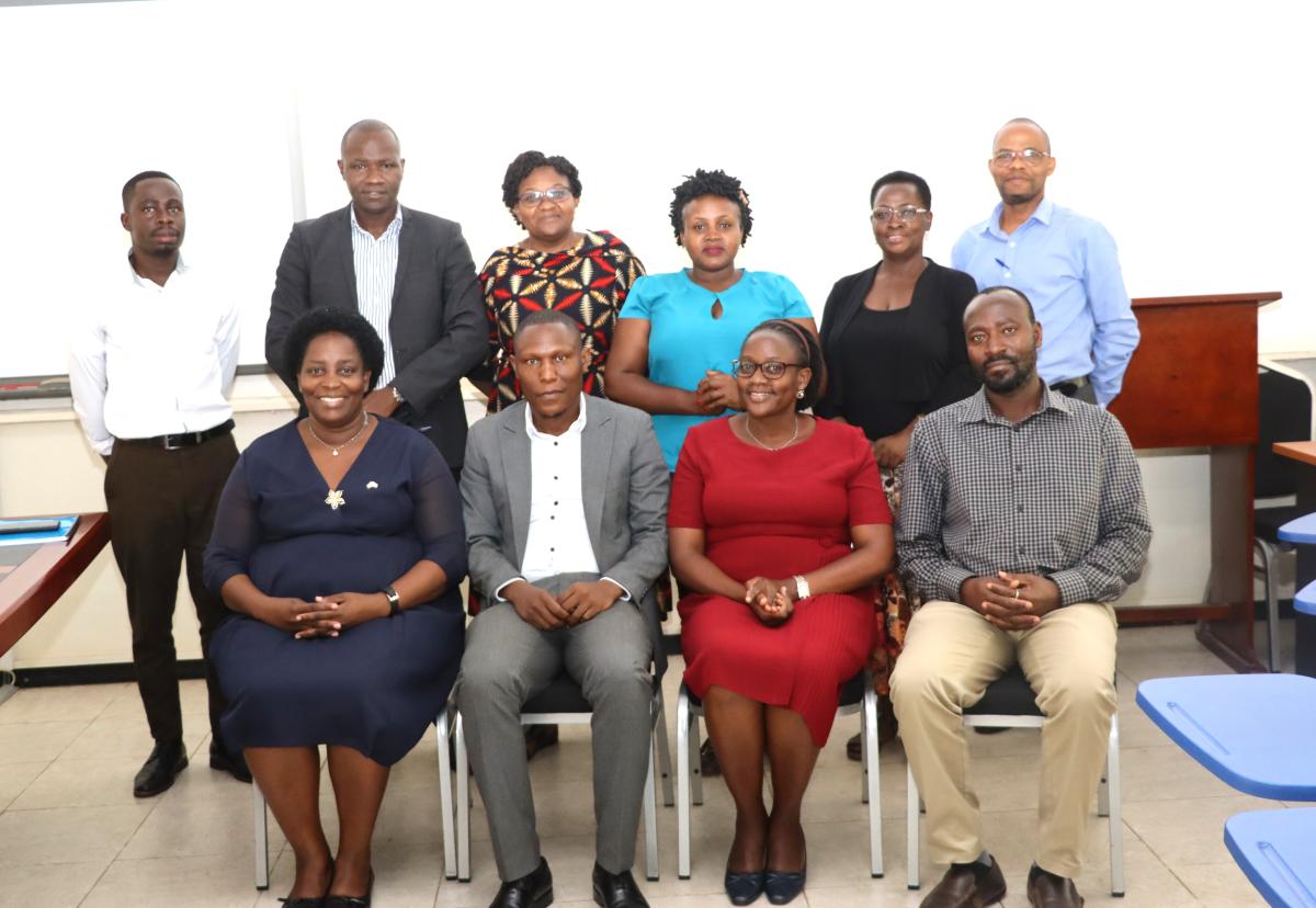 Attendees in a group photo after the handover ceremony. Handover of the College of Humanities and Social Sciences (CHUSS) Bursar Office from Ms. Joseline Biganja to Mr. Michael Mbaine, 6th August 2024, CHUSS Smart Room, Makerere University, Kampala Uganda, East Africa.