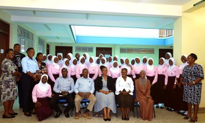 CoBAMS Staff pose for a group photo with staff and students of Mbogo High School. College of Business and Management Sciences(CoBAMS), Senior 6 students from Mbogo High School Career Guidance Session, August 2024, Yusuf Lule Central Teaching Facility, Makerere University, Kampala Uganda, East Africa.