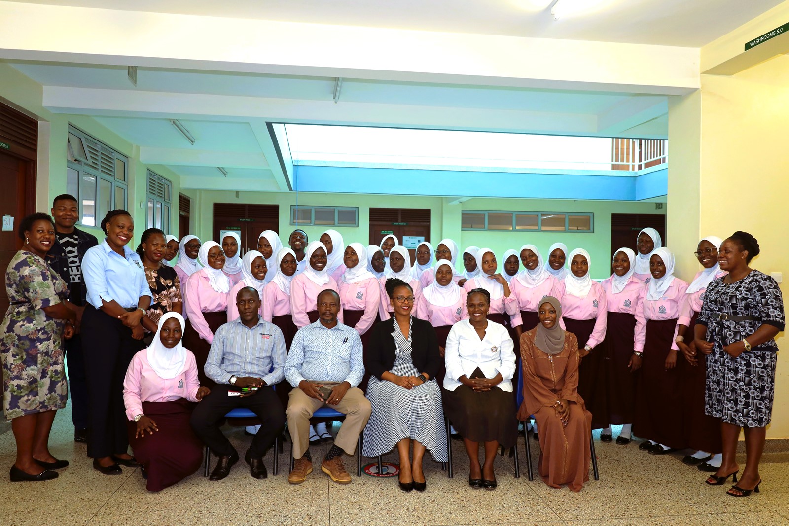 CoBAMS Staff pose for a group photo with staff and students of Mbogo High School. College of Business and Management Sciences(CoBAMS), Senior 6 students from Mbogo High School Career Guidance Session, August 2024, Yusuf Lule Central Teaching Facility, Makerere University, Kampala Uganda, East Africa.