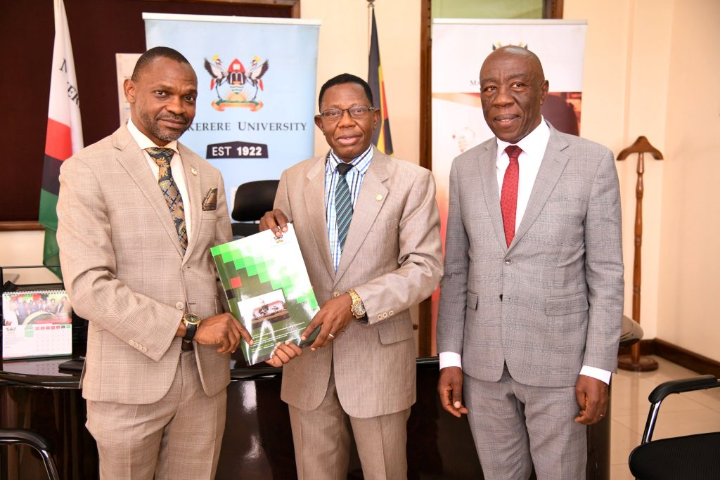 Right to Left: Prof. Henry Alinaitwe, witnesses as Prof. Buyinza Mukadasi receives the handover report from Assoc. Prof. Umar Kakumba. 