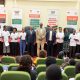 A cross-section of Scholars pose in a photo with the Vice Chancellor and Mr. Bukenya after receiving their Scholarship award letters. Mastercard Foundation Scholars Program Scholarships Award Ceremony, 20th August 2024, Makerere University School of Public Health Auditorium, Kampala Uganda, East Africa.