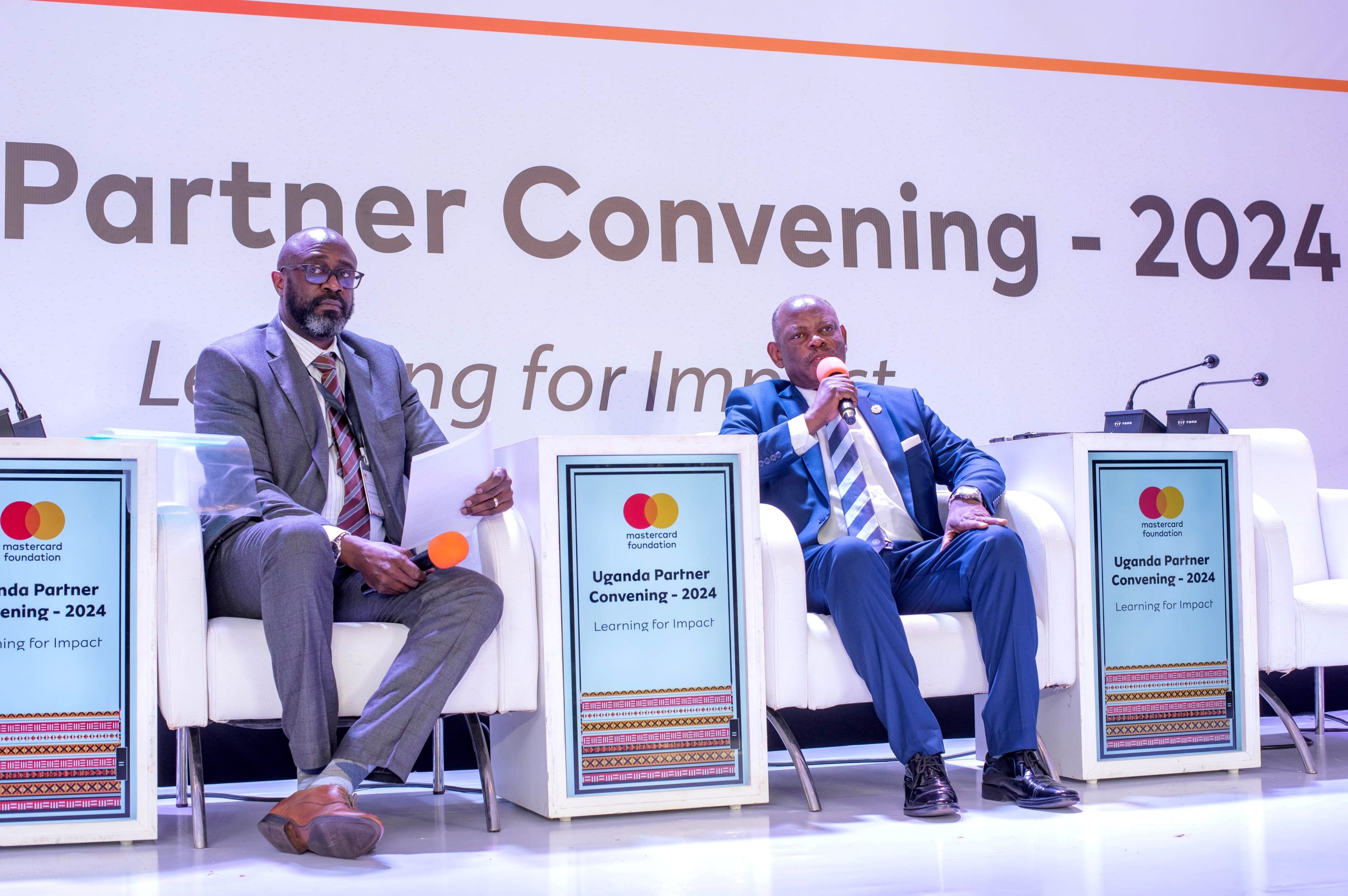 Prof. Barnabas Nawangwe (R) flanked by Mr. Adrian Bukenya, the Country Director of Mastercard Foundation (L), during the panel discussion.