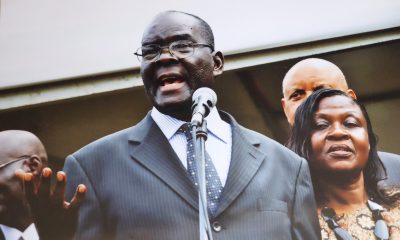 Mr. Grace Wilson Igaga Mutekanga sings the Makerere University anthem at the Mak@90 Grand Finale Celebrations on 3rd August 2013. Besides him is his wife Mrs. Frances Mutekanga and rear is former Chancellor, Prof. Mondo Kagonyera.