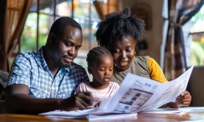 A family of three a father mother and daughter sit at a table looking at a newspaper. This photo was generated with AI.