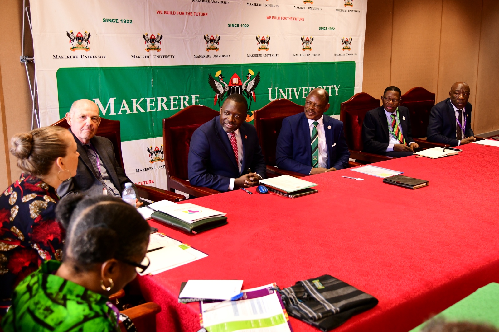 Right to Left: Prof. Henry Alinaitwe, Prof. Buyinza Mukadasi, Prof. Barnabas Nawangwe, Mr. Yusuf Kiranda and Prof. Steven Hanson listen to Dr. Amy Jamison during the meeting. Left with back to camera is Dr. Rose Jackson. Alliance for African Partnership (AAP) of Michigan State University (MSU) Annual Consortium Meeting. Hosted by Makerere University in the School of Public Health Conference Hall, Kampala Uganda, East Africa 9th-11th September 2024.