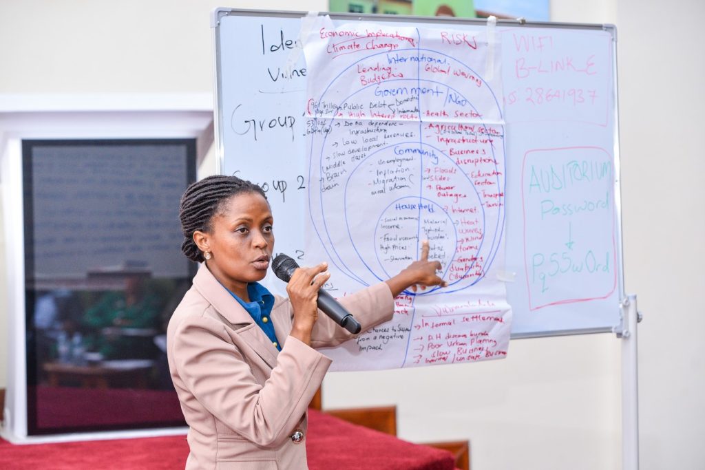 A participant presents her group report. Leiden-Delft-Erasmus East Africa Research Network (LEARN) in collaboration with the Urban Action Lab at Makerere University a workshop to deliberate strategies for mitigating the impacts of climate change in urban centres in the East African Region, Theme: “Resilient Urban Futures: Adapting Livelihoods to Climate Change”, 4th-5th September 2024, School of Public Health Auditorium, Kampala Uganda.